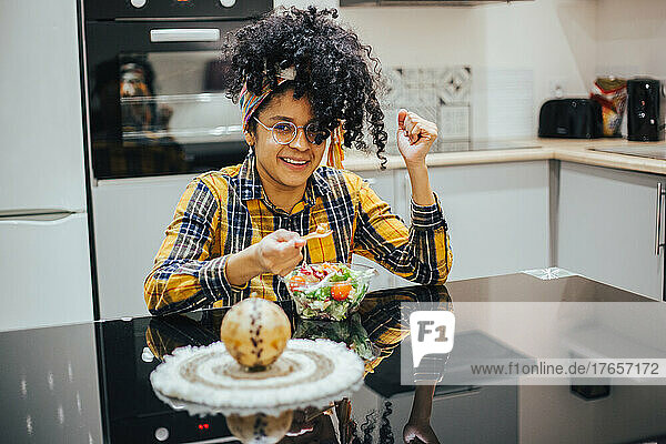 Afro woman eating healthy at home