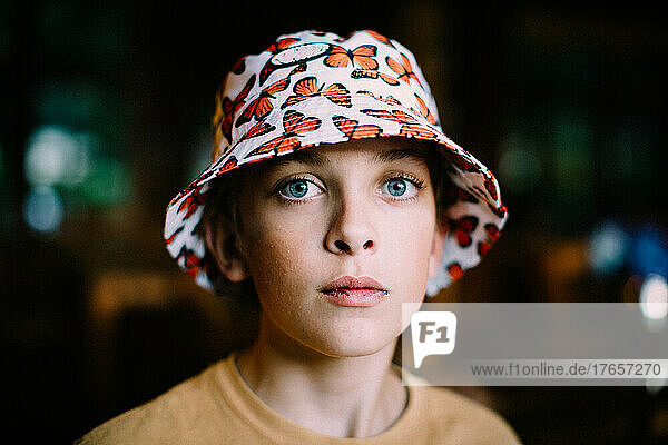 Close Up Portrait of Blue Eyed Boy in Butterfly Bucket Hat