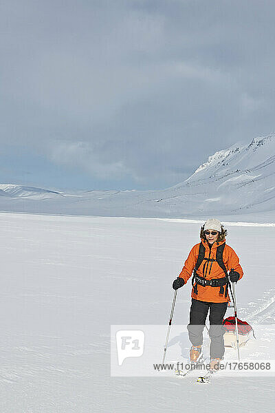 woman on touring ski's dragging sled through the Icelandic highlands