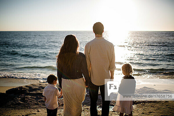 Family of Four Facing the Ocean at Sunset in San Diego