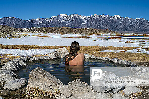 Female soaking in natural hot springs