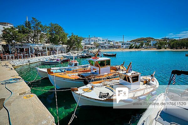 Fishing boats in harbour fishing village of Pollonia with fishing boats moored to pier in sea. Pollonia town  Milos island  Greece