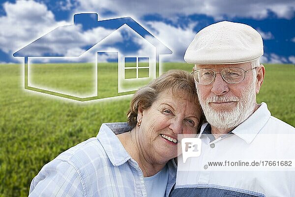 Loving senior couple standing in graß field with ghosted house on the horizon
