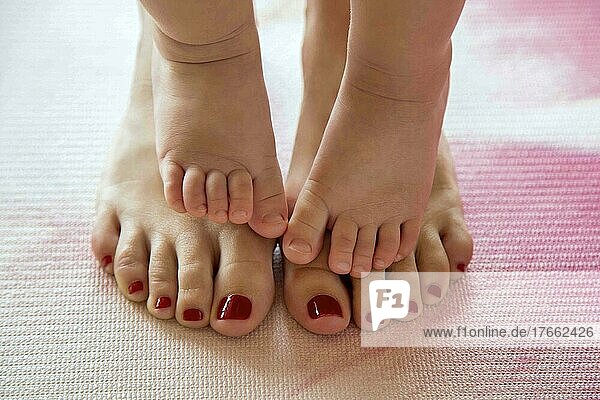 Baby toes on her mother's feet