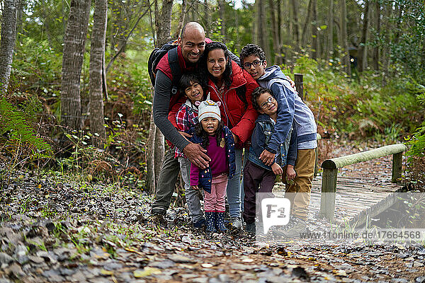 Portrait happy family hiking in woods