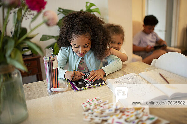 Girl coloring at table
