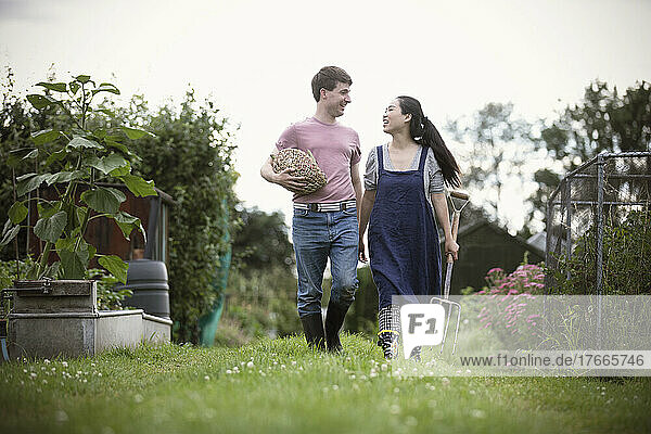 Happy couple walking in vegetable garden