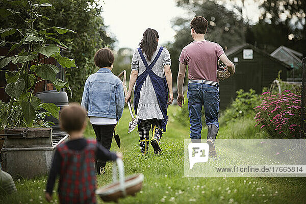 Family walking in backyard garden grass