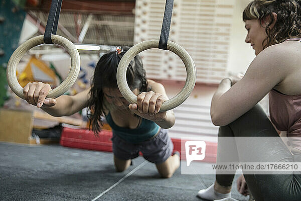 Female rock climbers training in climbing gym