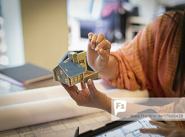 Architect looking at tiny house model