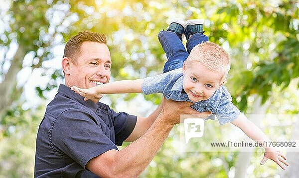 Young caucasian father and son having fun at the park