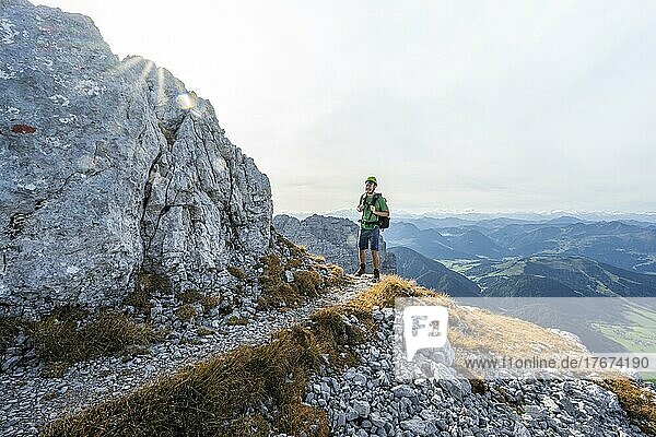 Hiker on hiking trail  climbing the Mitterhorn  Nuaracher Höhenweg  Loferer Steinberge  Tyrol  Austria  Europe