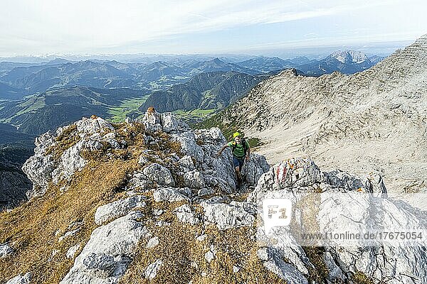 Hiker with climbing helmet  climbing the Mitterhorn  view of mountain landscape  Nuaracher Höhenweg  Loferer Steinberge  Tyrol  Austria  Europe