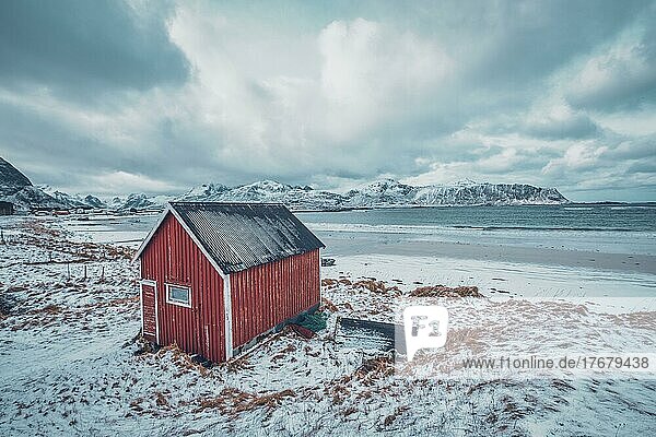 High Dynamic Range (HDR) Bild eines roten Rorbu-Hauses am Strand eines Fjords. Skagsanden Strand  Lofoten  Norwegen  Europa