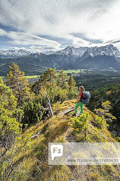 Young hiker on the trail to the Kramer  Wetterstein Mountains at the back  Garmisch  Bavaria  Germany  Europe