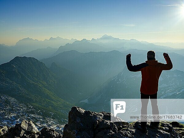 Climbers in victory pose at the summit of Krn 2. 244m  Triglav National Park  Julian Alps  Slovenia  Europe
