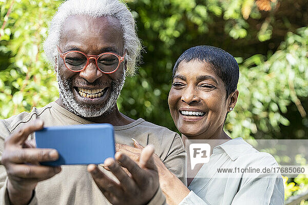 Smiling couple taking selfie with smart phone