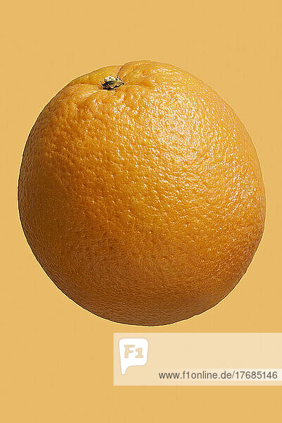 Close up dimples on vibrant  whole orange
