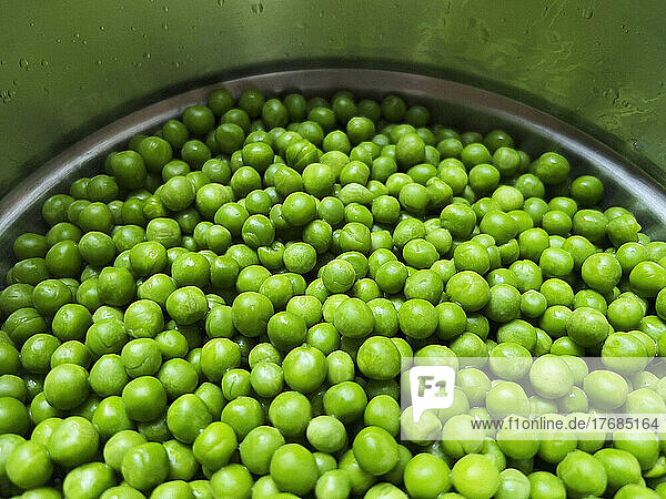 Close up vibrant green peas in pot