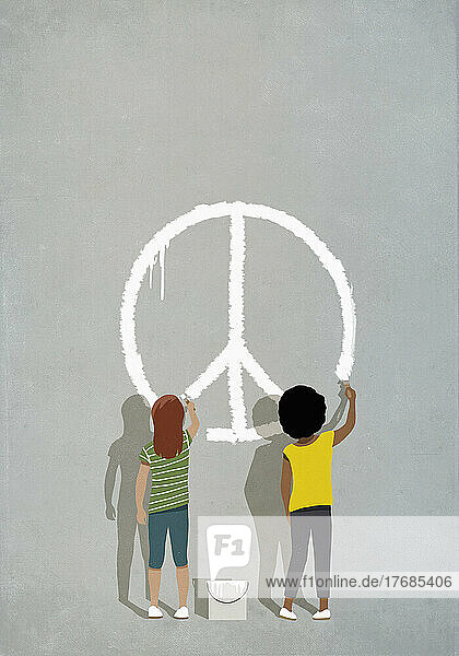 Multiracial girls painting peace sign on wall