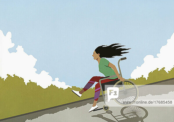 Happy  carefree woman speeding downhill in wheelchair