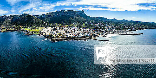 Spain  Balearic Islands  Colonia de Sant Pere  Helicopter panorama of coastal town in summer with mountains in background