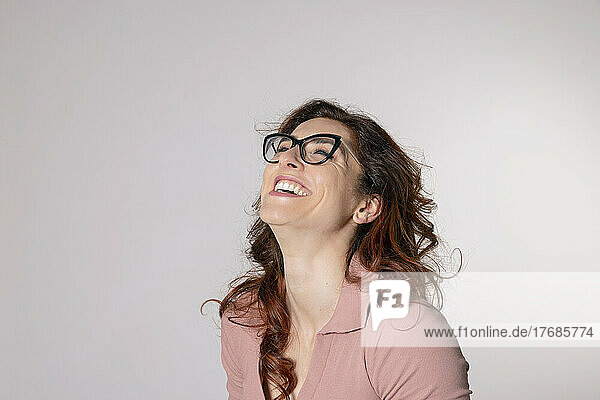Happy woman wearing eyeglasses against white background