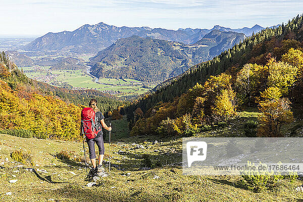 Germany  Bavaria  Female hiker admiring view on way to Geigelstein mountain