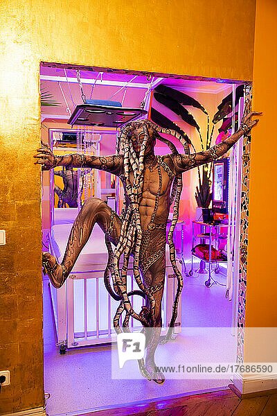 Man wearing spooky Medusa costume standing in doorway of SM studio