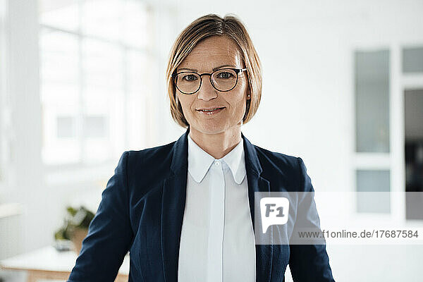 Smiling businesswoman wearing blazer in office