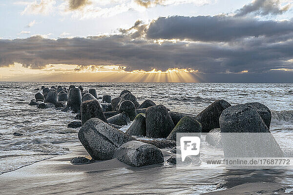 Germany  Schleswig-Holstein  Hornum  Beach tetrapods at cloudy sunset