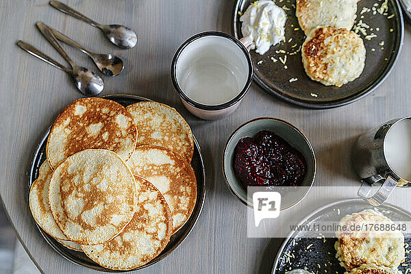 Breakfast on table with pancakes and jam