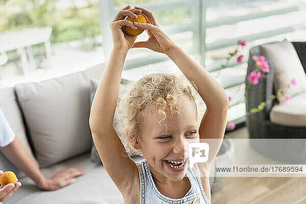 Happy girl with Easter egg having fun in living room at home