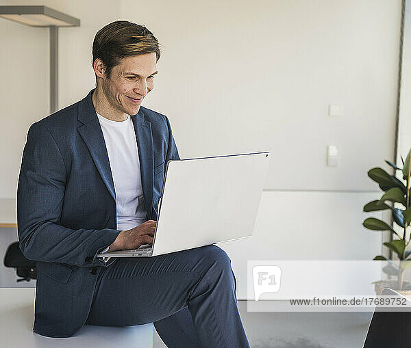 Businessman using laptop in office