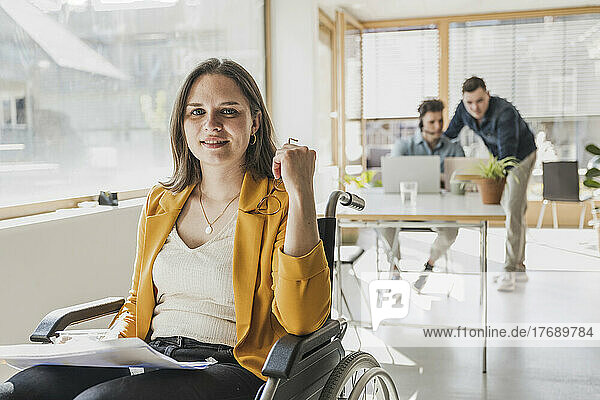 Portrait of young businesswoman in wheelchair in office