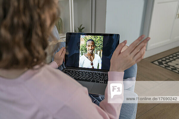 Woman on video call through tablet PC at home