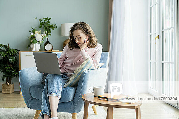 Businesswoman working on laptop at home