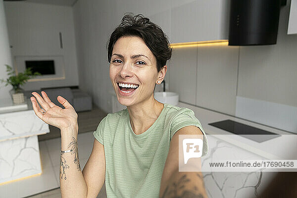 Happy woman taking selfie at home