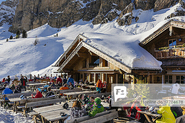 Skiers at a resort and chalet in The Dolomites  Gardena Valley of the Cir group  Veneto  Italy; Trentino-Alto Adige  South Tyrol  Italy