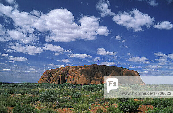 A View Of Uluru (Ayres Roack) Across The Desert Scrublands  Australia.