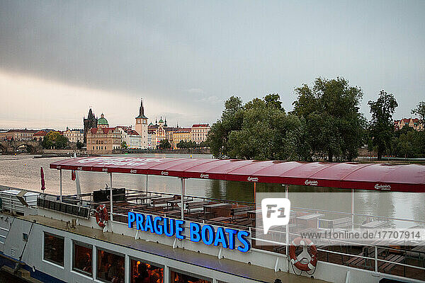 A dinner boat for tourists cruises on the Vltava River near The Old Town in Prague.; Prague  Czech Republic