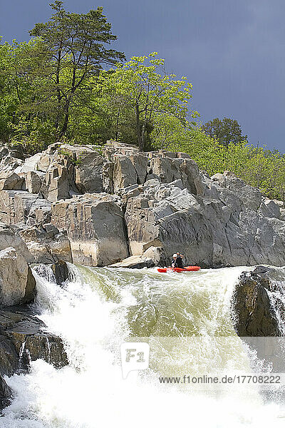 C-1 paddler takes his final strokes before plummeting over the Spout  the Virginia side of Great Falls on the Potomac River; Great Falls  Virginia  United States of America