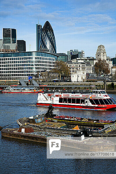 The Gherkin Building Dominates The Skyline With Tourists Boats And Scrap Barges On The Thames; London  England