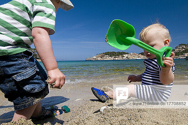 Baby And Young Child Playing On Beach; Majorca  Spain