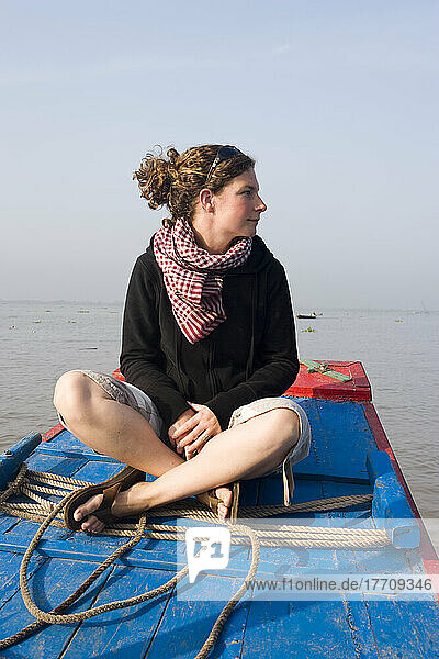 Young Woman Enjoying A Boat Trip In The Mekong Delta Close To Vinh Long  Vietnam.