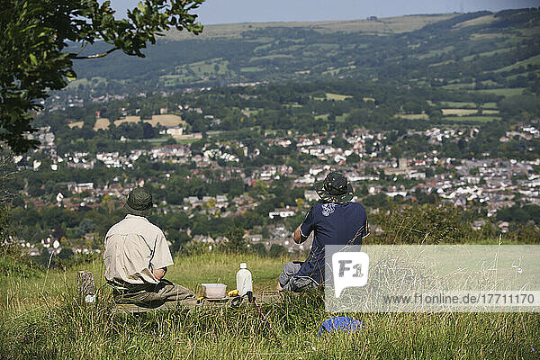 Hikers Having A Picnic Lunch Rest On The Famous National Trail 100 Mile Cotswold Way Trail Above Cheltenham; Gloucestershire  England
