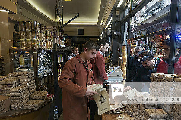 Customers Lined Up At A Shop Window As Workers Package Their Purchases; Istanbul  Turkey