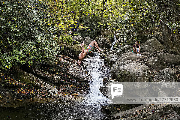 A young man dives into Skinny Dip Falls near Looking Glass Overlook in the Blue Ridge Mountains of North Carolina; North Carolina  United States of America