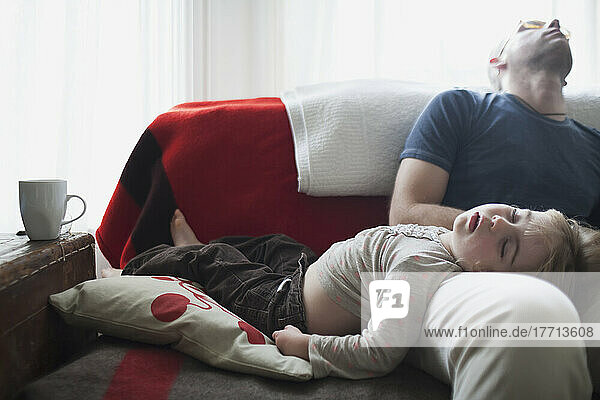 Father And Daughter Crashed Out Asleep On Sofa; Toronto  Ontario  Canada