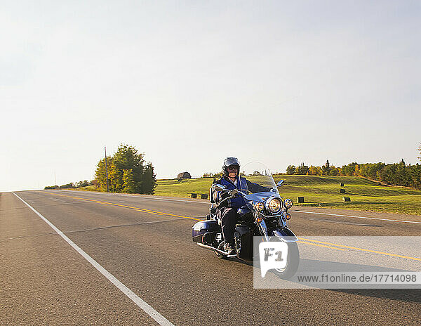 Älterer Mann fährt ein Motorrad auf der Autobahn; Edmonton  Alberta  Kanada